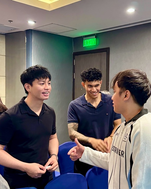 Three young men laughing together during an icebreaker