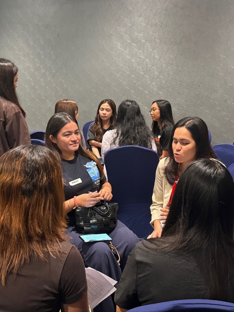 Small groups of women sitting in circles, talking